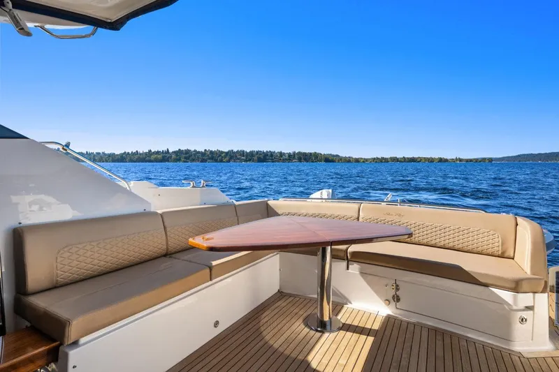 Slide: The Image of 2017 Sea Ray L590 Sport yacht with elegant seating and scenic water view. - 36