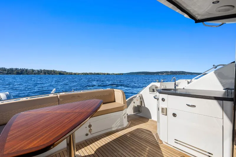 Slide: The Image of 2017 Sea Ray L590 Sport yacht deck with seating and ocean view. - 37