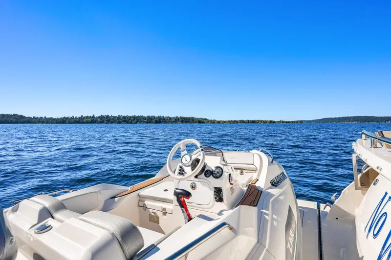 Slide: The Image of 2017 Sea Ray L590 Sport yacht on open water, clear blue sky. - 40