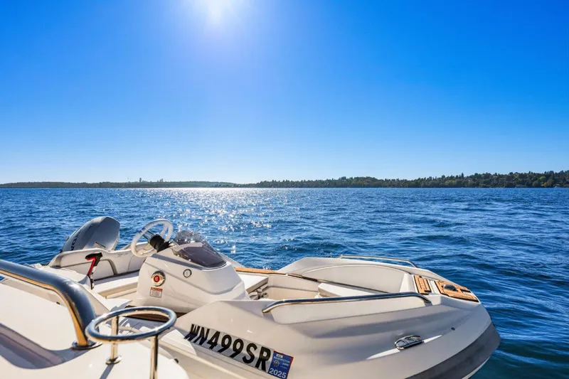 Slide: The Image of 2017 Sea Ray L590 Sport yacht cruising on a sunny, blue ocean. - 41