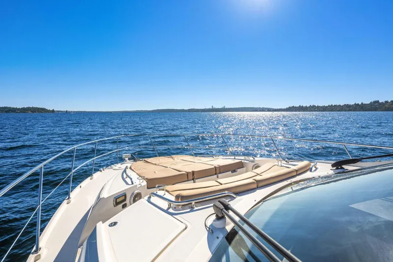 Slide: The Image of 2017 Sea Ray L590 Sport yacht cruising on a sunny day, with clear blue skies and water. - 43