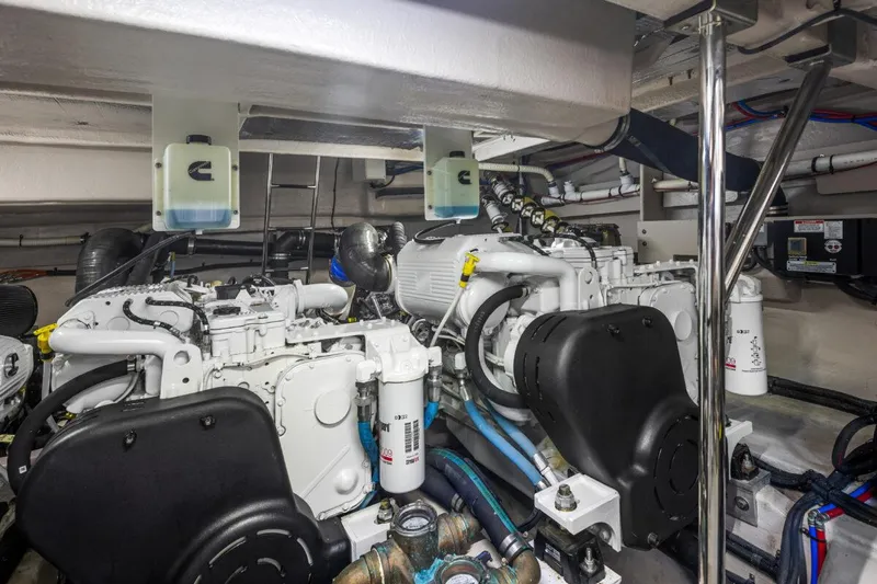Slide: The Image of Engine room of 2017 Sea Ray L590 Sport yacht, showcasing dual engines and mechanical components. - 48