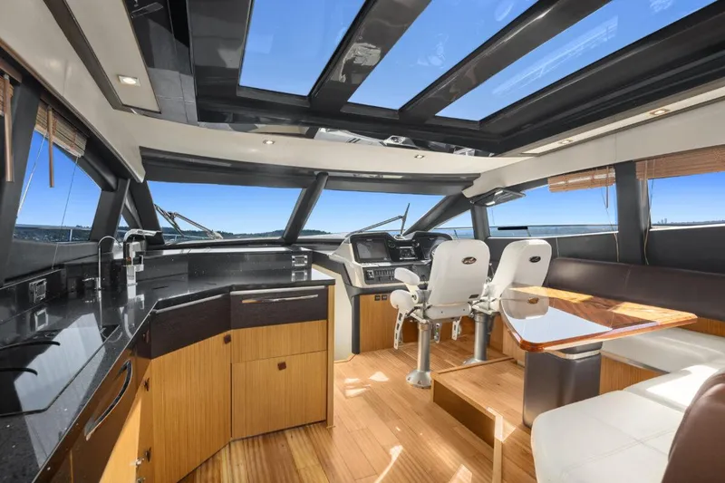 Slide: The Image of Luxurious 2017 Sea Ray L590 Sport yacht interior with modern helm and panoramic windows. - 7