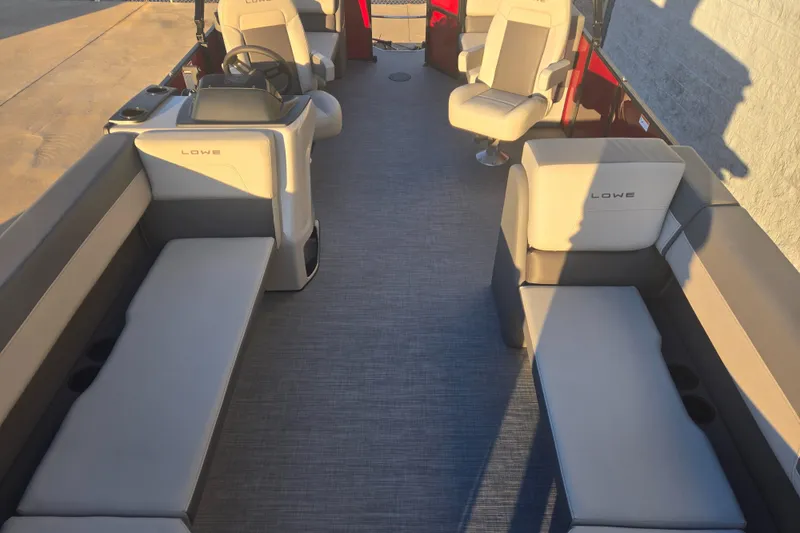 Slide: The Image of 2025 Lowe LS210WT boat interior with spacious seating and modern design. - 2