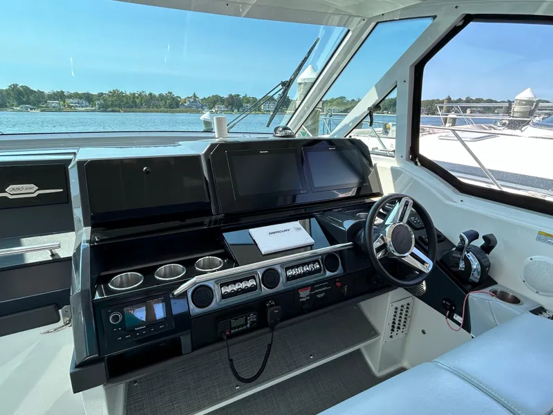 Slide: The Image of 2020 Formula 380 Super Sport Crossover helm with modern controls and scenic water view. - 10