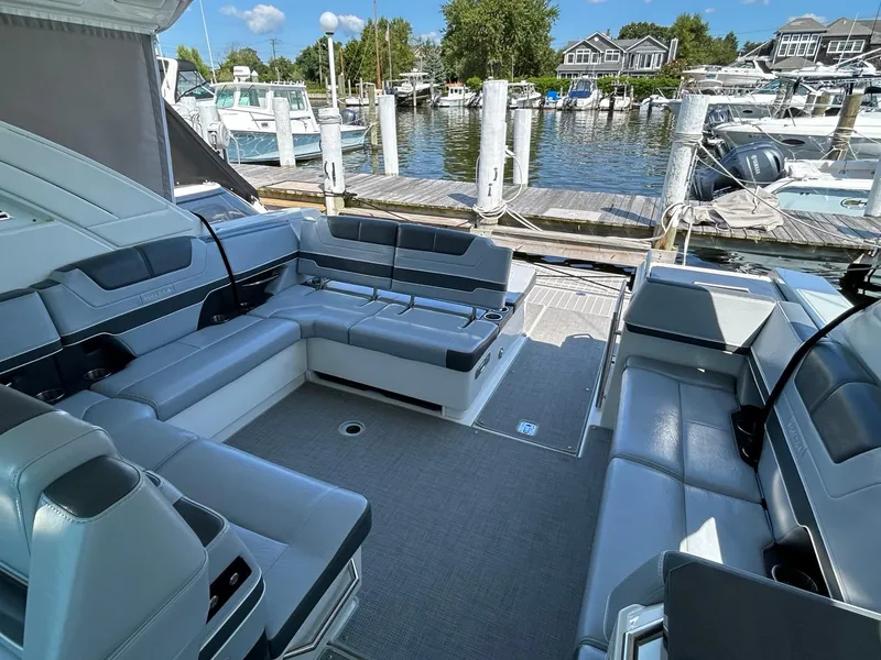 Slide: The Image of 2020 Formula 380 Super Sport Crossover boat interior at marina, featuring spacious seating. - 12