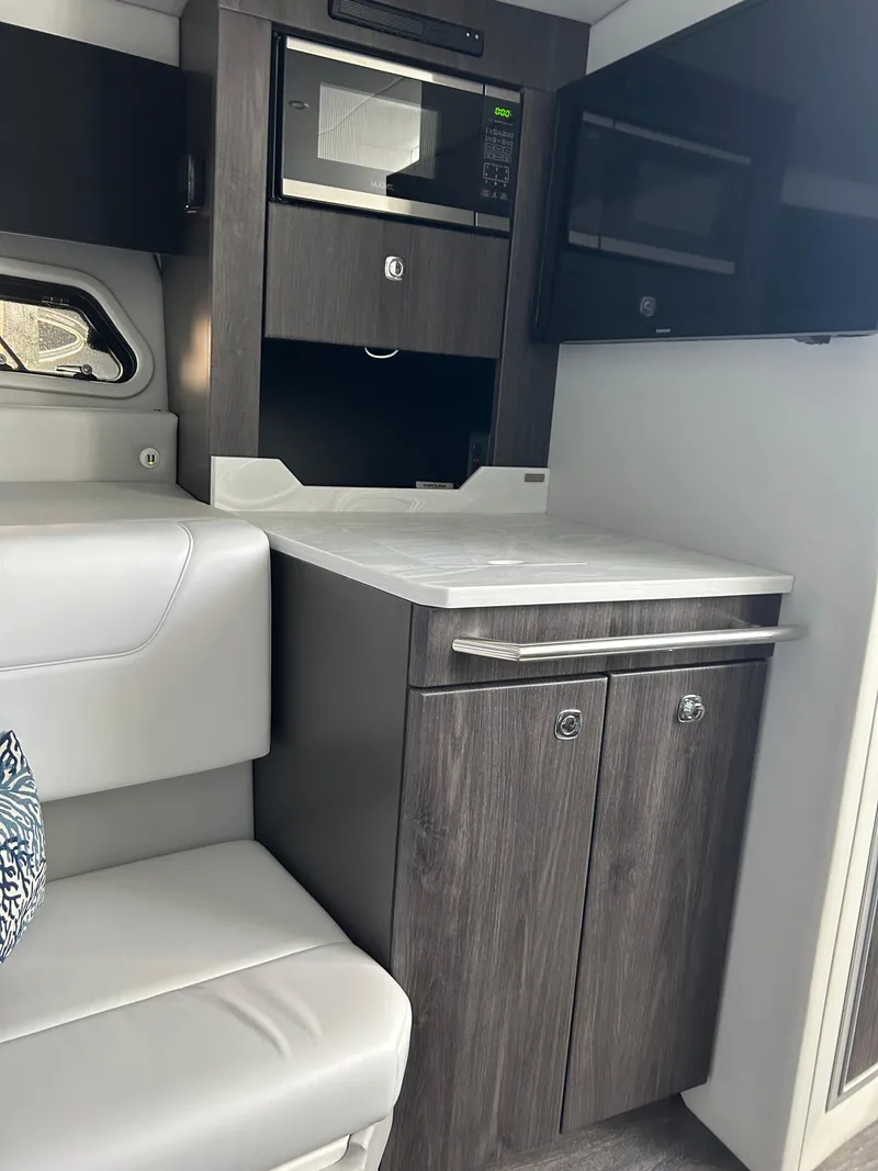 Slide: The Image of 2020 Formula 380 Super Sport Crossover interior with modern kitchenette and seating. - 23