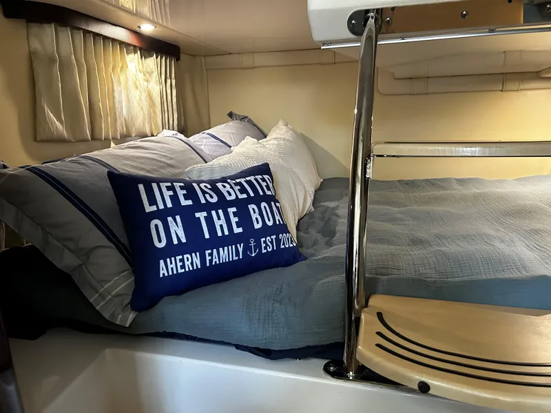 Slide: The Image of Cozy cabin interior of 2014 Regal 28 Express with nautical-themed bedding. - 15