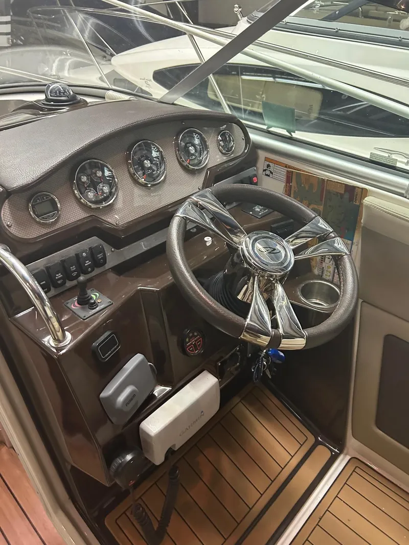 Slide: The Image of 2014 Regal 28 Express boat dashboard with steering wheel and instrument panel. - 3