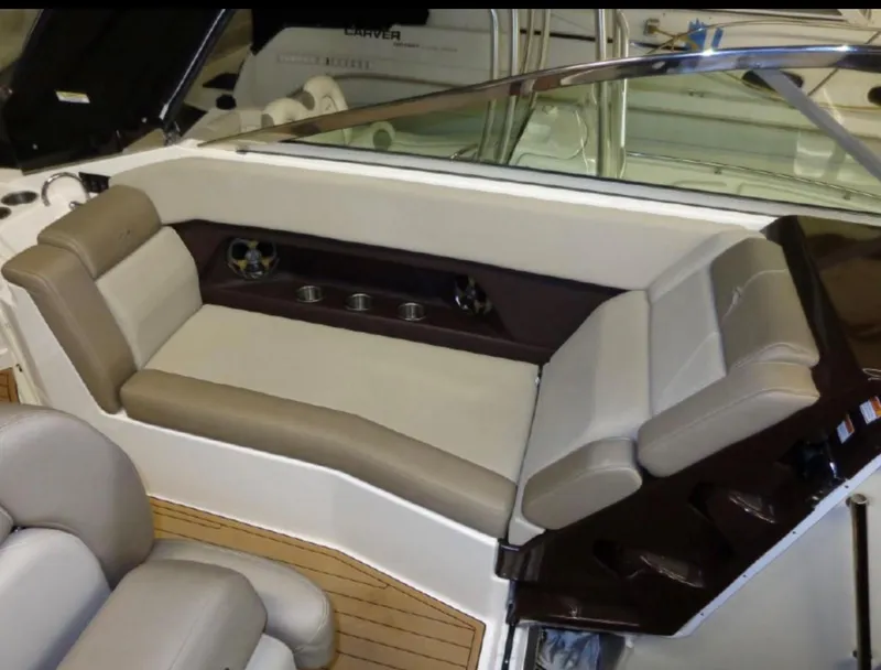 Slide: The Image of 2014 Regal 28 Express boat interior with beige seating and wood accents. - 8