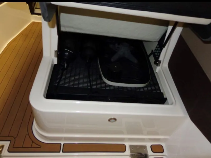 Slide: The Image of Storage compartment in a 2014 Regal 28 Express boat with wooden flooring. - 9