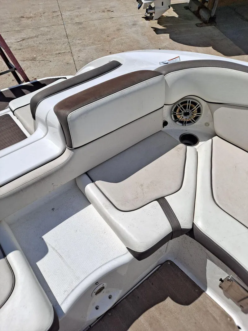 Slide: The Image of 2013 Yamaha Boats 242 Limited S interior seating with speaker and cup holder. - 10