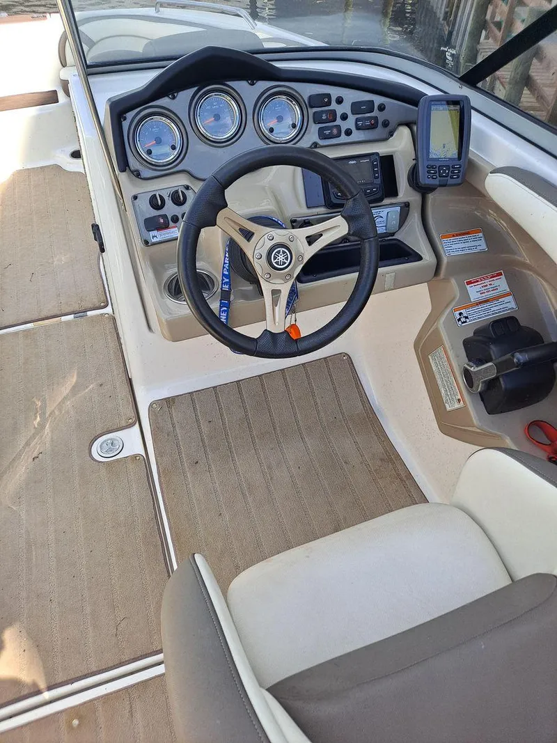 Slide: The Image of 2013 Yamaha Boats 242 Limited S dashboard with steering wheel and navigation controls. - 16