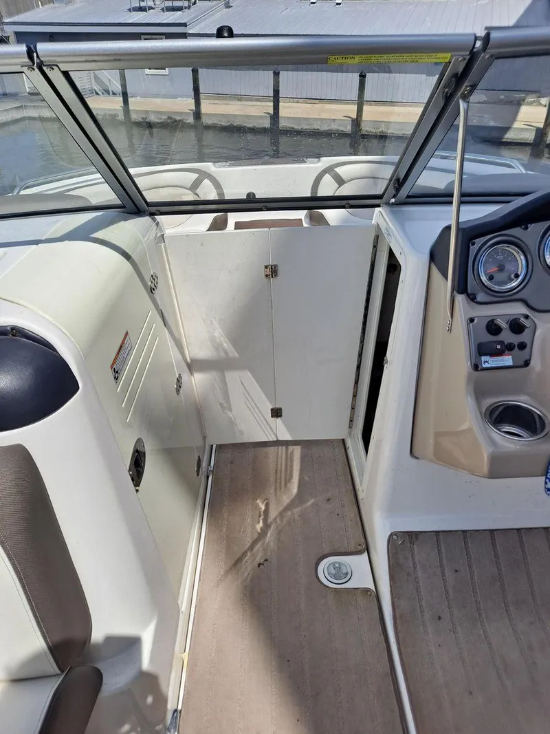 Slide: The Image of 2013 Yamaha Boats 242 Limited S interior with steering console and seating area. - 21