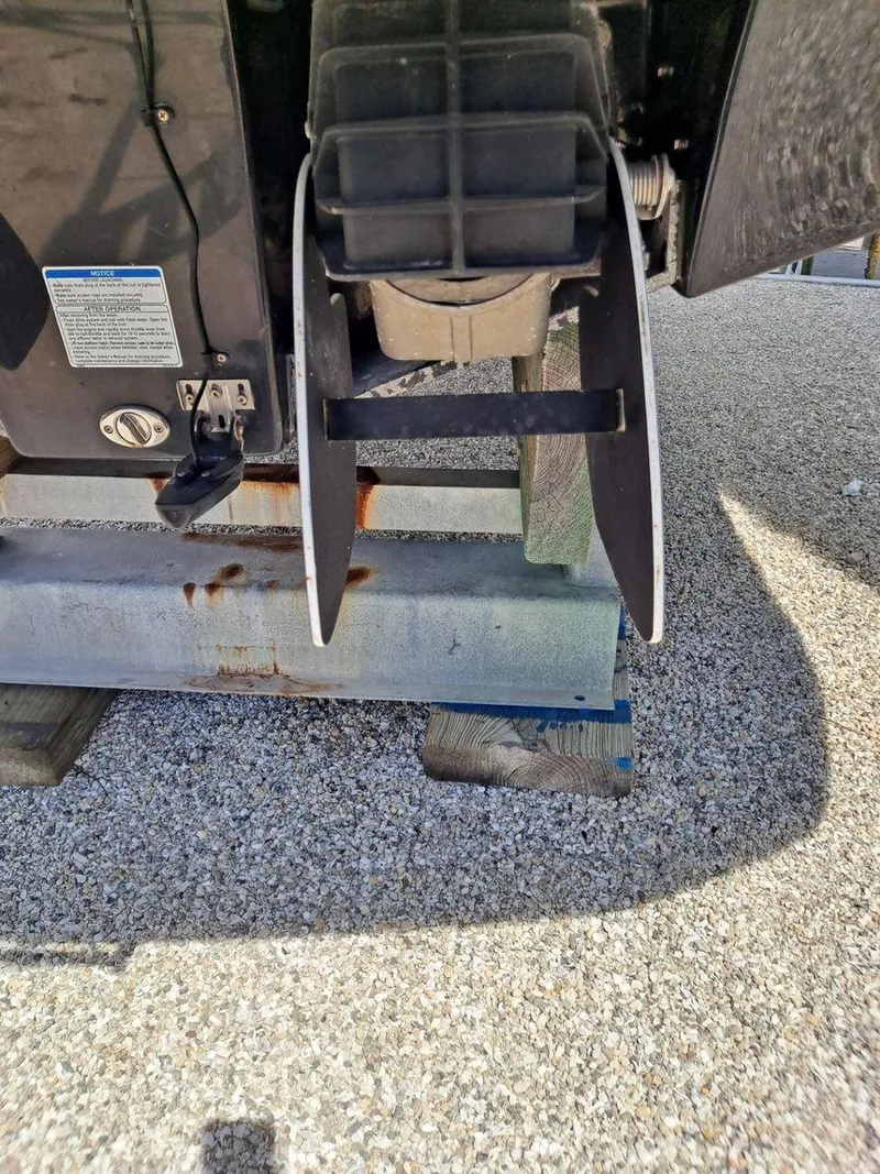 Slide: The Image of Close-up of 2013 Yamaha Boats 242 Limited S engine part on gravel surface. - 38