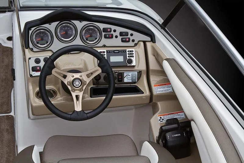 Slide: The Image of 2013 Yamaha Boats 242 Limited S dashboard with steering wheel and controls. - 44