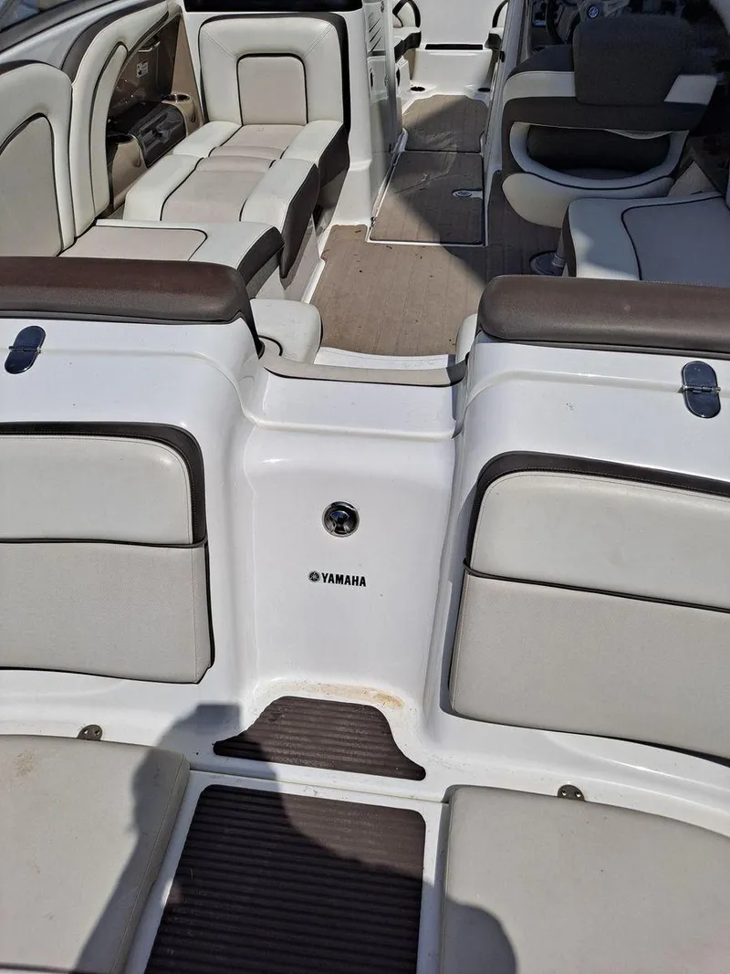 Slide: The Image of 2013 Yamaha Boats 242 Limited S interior with white and brown seating. - 7
