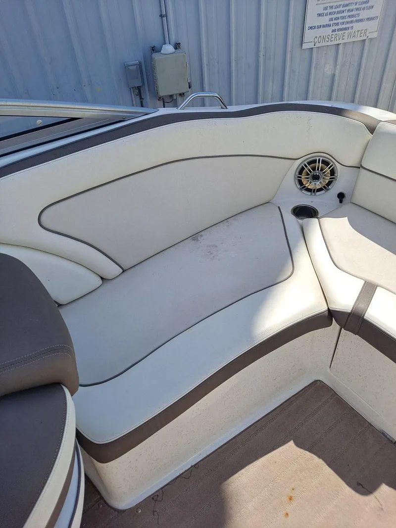 Slide: The Image of 2013 Yamaha Boats 242 Limited S interior seating with speaker and cup holder. - 8