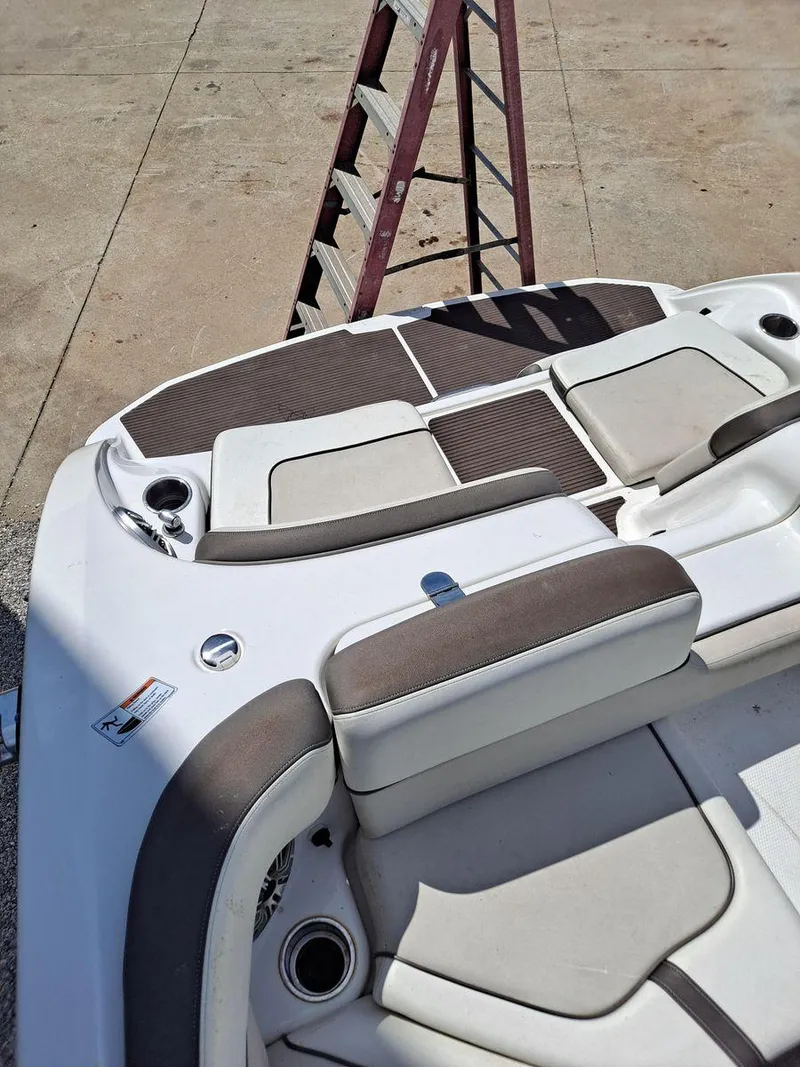 Slide: The Image of 2013 Yamaha Boats 242 Limited S interior with cushioned seating and cup holders. - 9