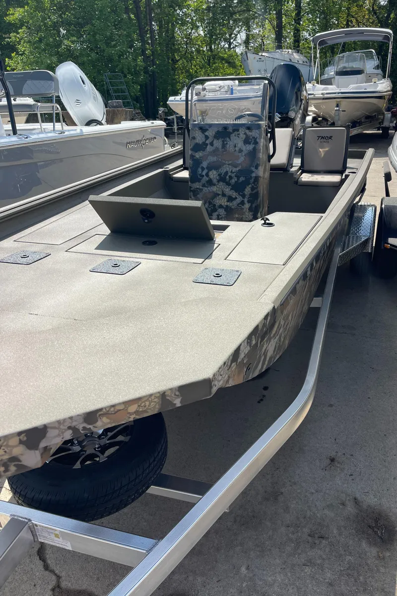 The Image of 2024 Thor 1900 Lake Hammer Center Console boat on trailer, parked outdoors. - 0