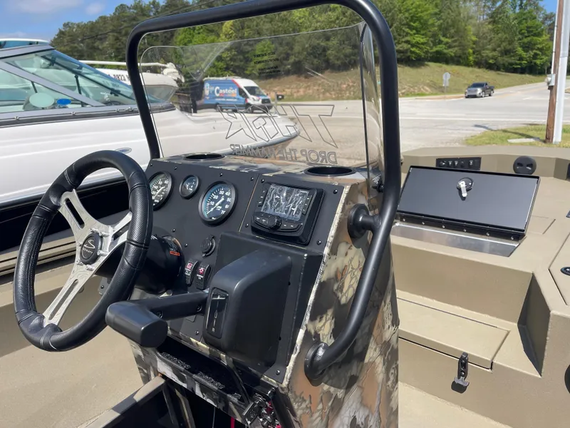 Slide: The Image of 2024 Thor 1900 Lake Hammer Center Console boat interior with steering wheel and dashboard controls. - 2