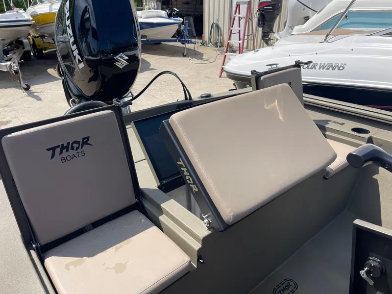 Slide: The Image of 2024 Thor 1900 Lake Hammer Center Console boat with beige seating and Suzuki outboard motor. - 3