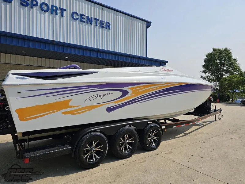 Slide: The Image of 2004 Baja 30 Outlaw boat on trailer outside sports center. - 10