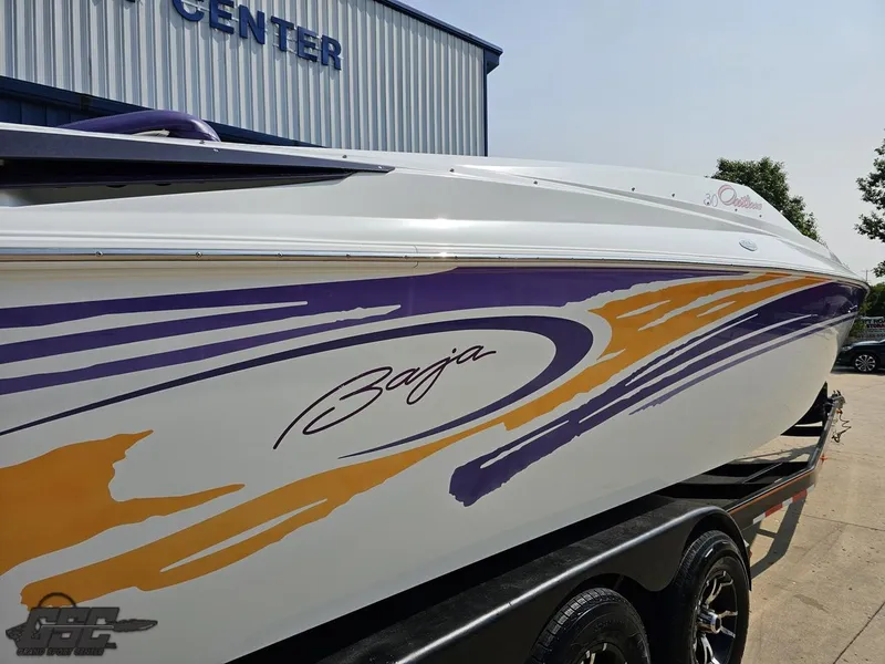 Slide: The Image of 2004 Baja 30 Outlaw boat with vibrant purple and orange graphics. - 11