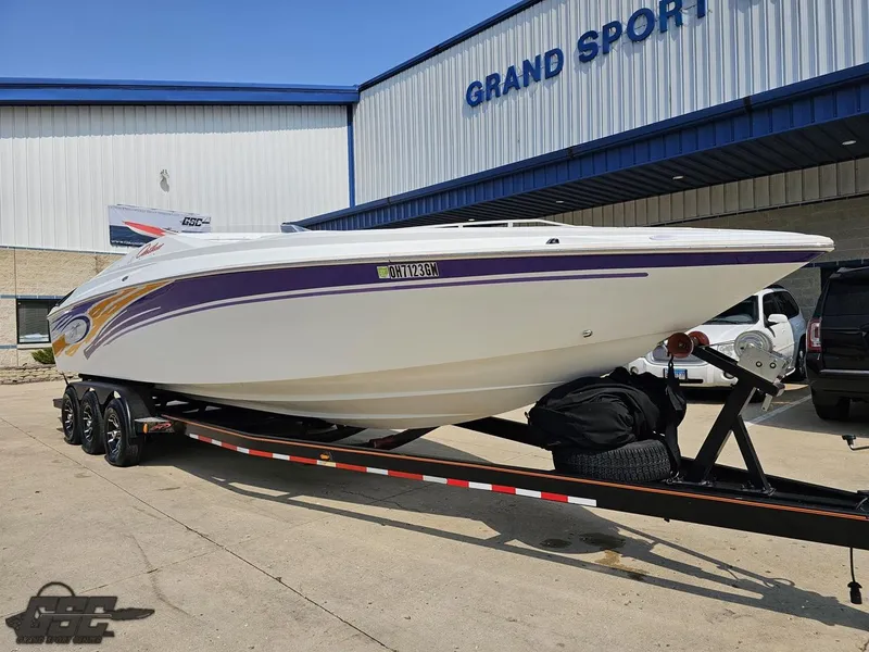 Slide: The Image of 2004 Baja 30 Outlaw speedboat on trailer outside Grand Sport facility. - 16