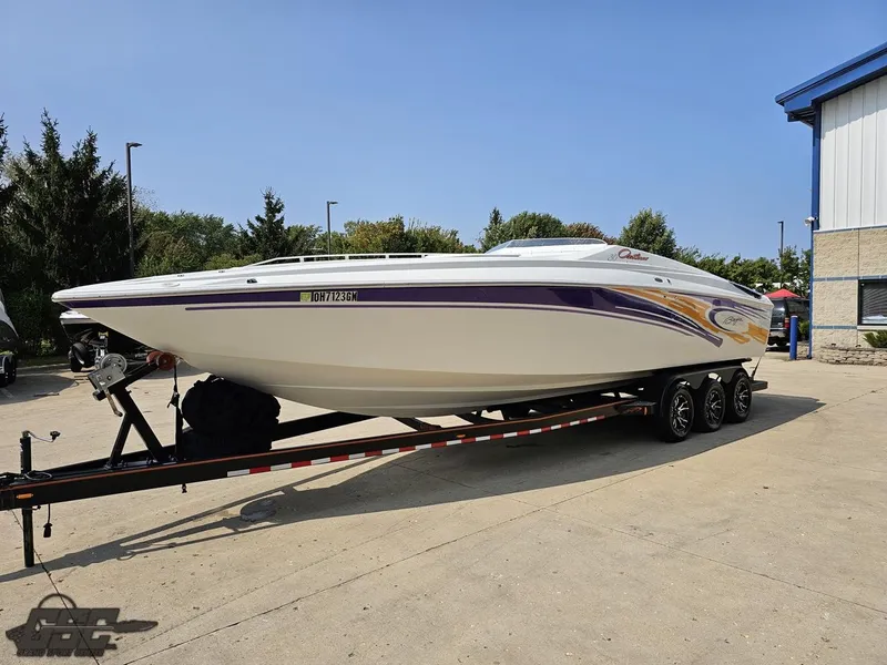 Slide: The Image of 2004 Baja 30 Outlaw speedboat on trailer, parked outdoors. - 20