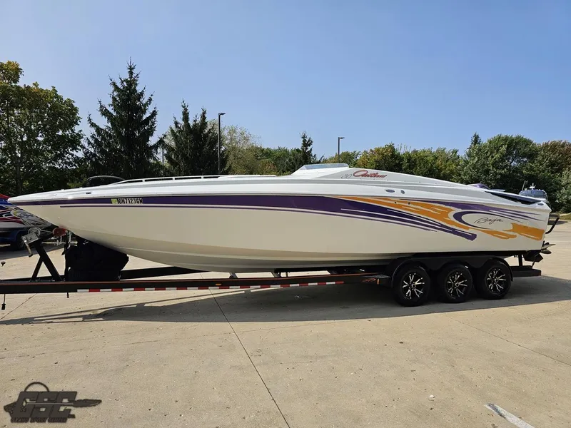 Slide: The Image of 2004 Baja 30 Outlaw speedboat on trailer, featuring sleek design and vibrant graphics. - 21