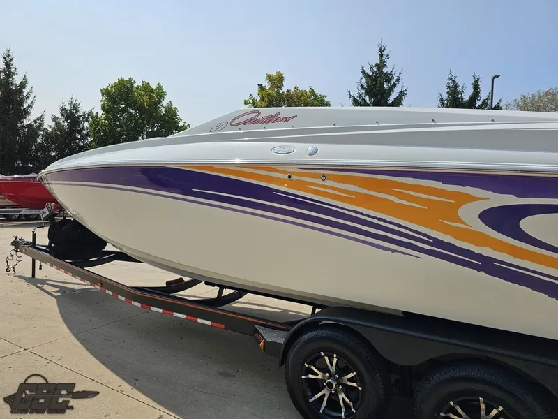 Slide: The Image of 2004 Baja 30 Outlaw speedboat with vibrant purple and orange graphics on a trailer. - 28