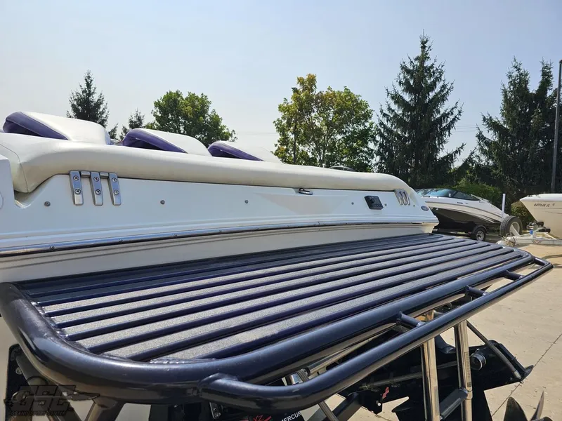 Slide: The Image of 2004 Baja 30 Outlaw boat with sleek design and purple accents. - 33