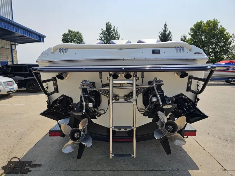 Slide: The Image of 2004 Baja 30 Outlaw boat rear view with dual propellers in a parking lot. - 34