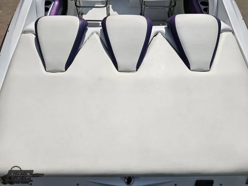 Slide: The Image of 2004 Baja 30 Outlaw boat interior with white and purple seating. - 43