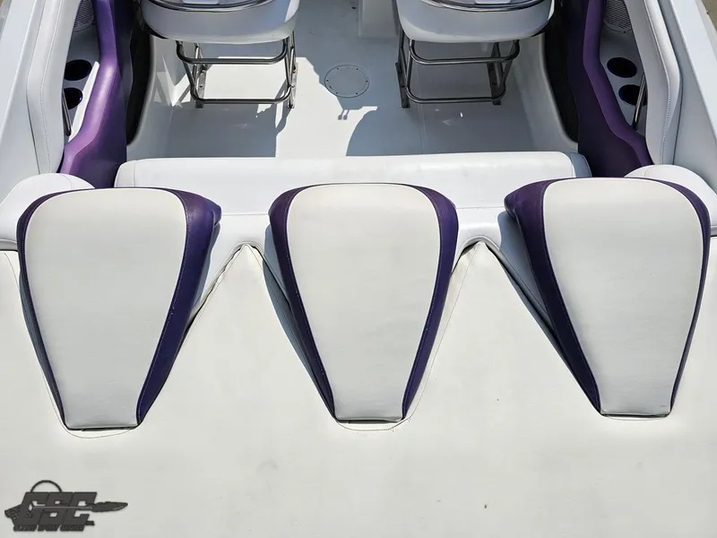 Slide: The Image of 2004 Baja 30 Outlaw boat interior with white and purple seating. - 45