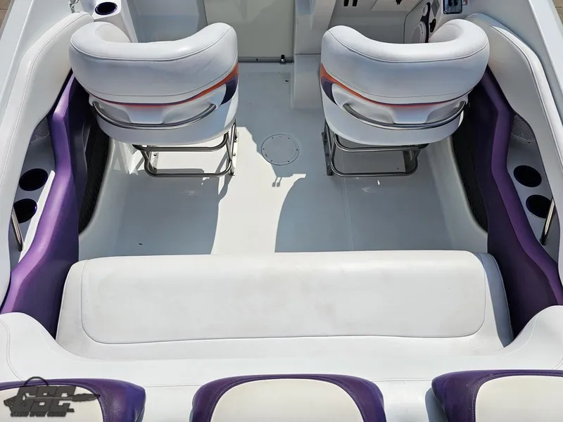 Slide: The Image of Interior of a 2004 Baja 30 Outlaw boat with white and purple seating. - 48