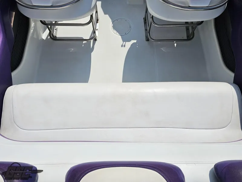 Slide: The Image of 2004 Baja 30 Outlaw boat interior with white and purple seating. - 49