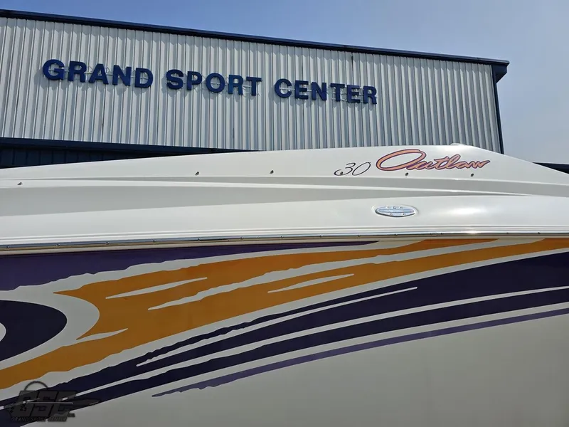 Slide: The Image of 2004 Baja 30 Outlaw boat at Grand Sport Center with colorful graphics. - 7