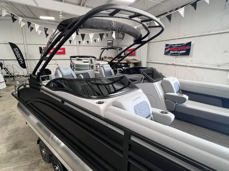 The Image of 2025 Harris Solstice DC 250 boat in showroom, sleek design with modern seating. - 0