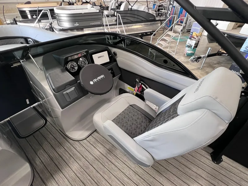 Slide: The Image of 2025 Harris Solstice DC 250 boat interior with modern dashboard and comfortable seating. - 11