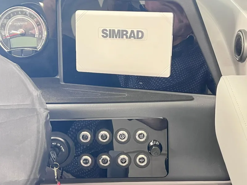 Slide: The Image of Dashboard of 2025 Harris Solstice DC 250 boat with Simrad display and control panel. - 14