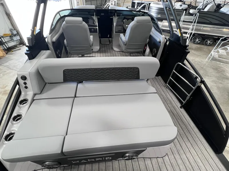 Slide: The Image of 2025 Harris Solstice DC 250 boat interior with gray seating and modern design. - 18