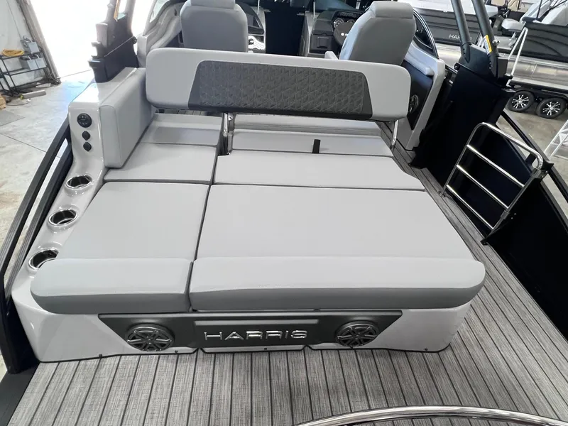 Slide: The Image of 2025 Harris Solstice DC 250 boat interior with gray seating and cup holders. - 20