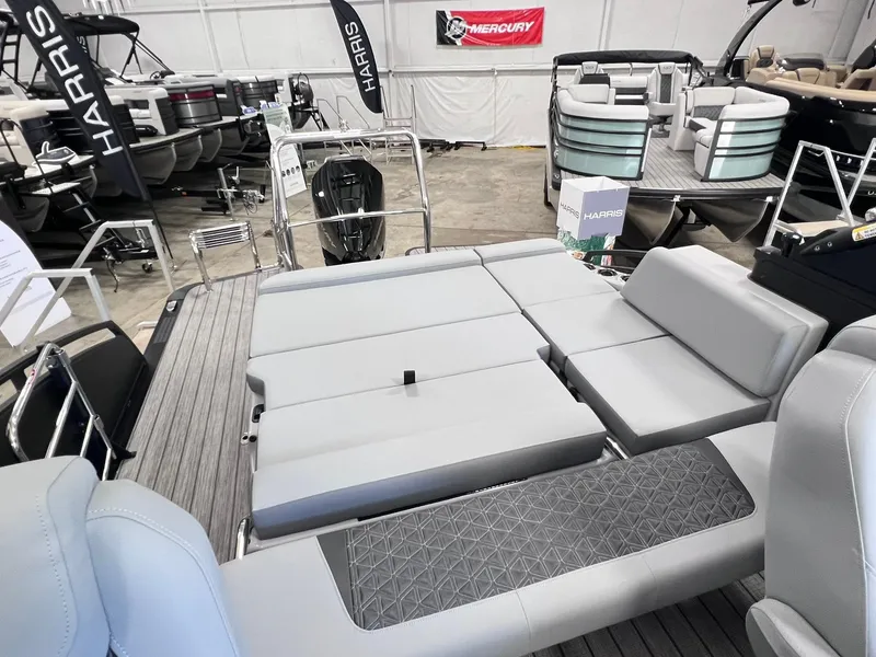 Slide: The Image of 2025 Harris Solstice DC 250 boat interior with gray seating in showroom. - 21