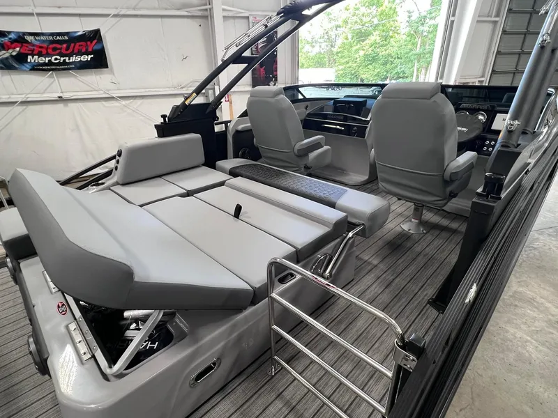 Slide: The Image of 2025 Harris Solstice DC 250 boat interior with gray seating and modern dashboard. - 23