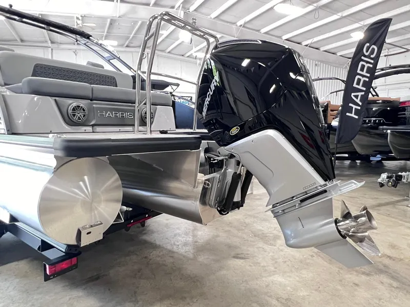 Slide: The Image of 2025 Harris Solstice DC 250 boat with powerful outboard motor in showroom. - 26