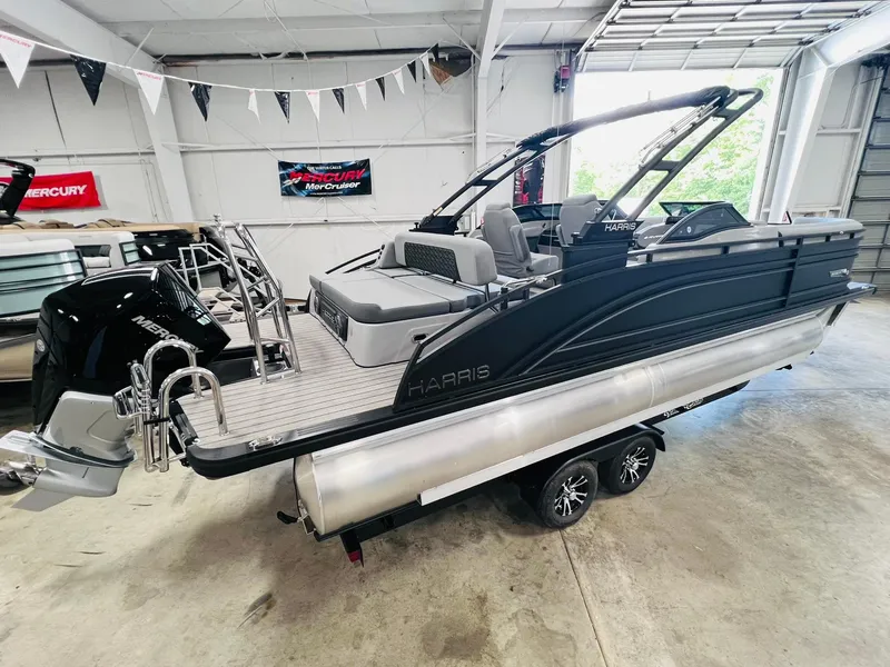 Slide: The Image of 2025 Harris Solstice DC 250 pontoon boat in showroom, featuring sleek design and modern amenities. - 4