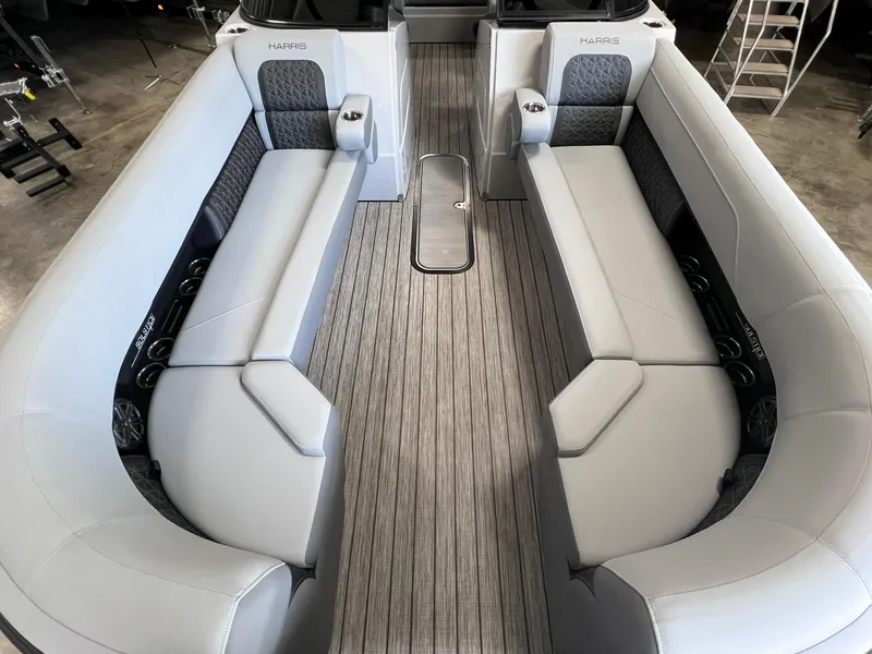 Slide: The Image of 2025 Harris Solstice DC 250 boat interior with sleek gray seating and modern design. - 5
