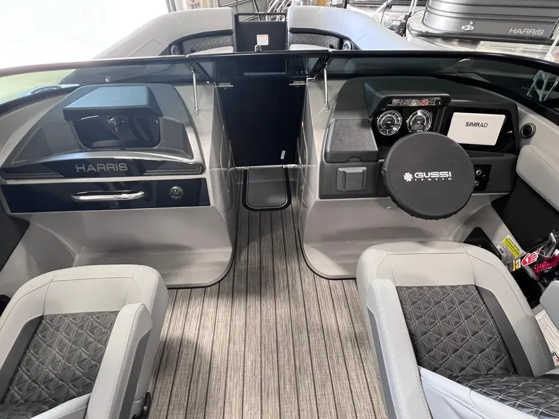 Slide: The Image of 2025 Harris Solstice DC 250 boat interior with modern dashboard and seating. - 7